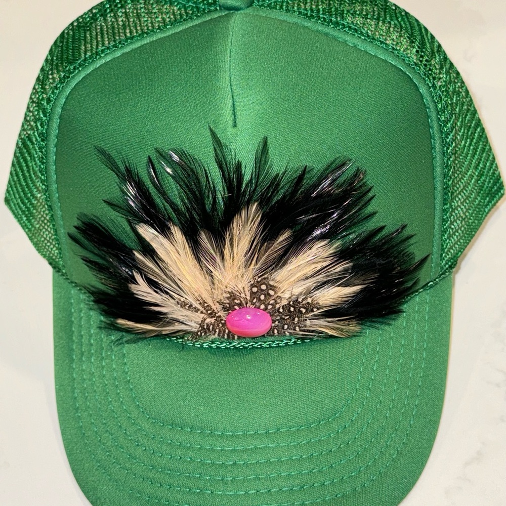 Kelly green trucker hat with feather and pink stone!
